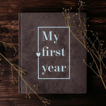 Dark grey baby book "My first year"